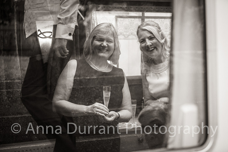 Bride and guest through Dutch barge window