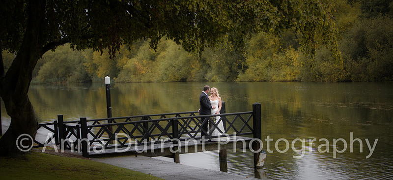 Romantic picture of bride and groom on jetty by river Thames