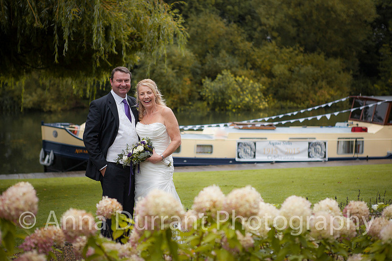 Bride and groom standing in front of Dutch barge