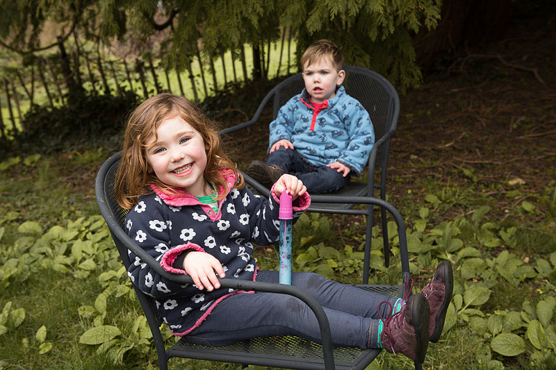 Brother and sister sitting on chairs